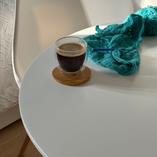 pexels-2155024982-33846130 A relaxing corner with a cup of coffee and a crochet project