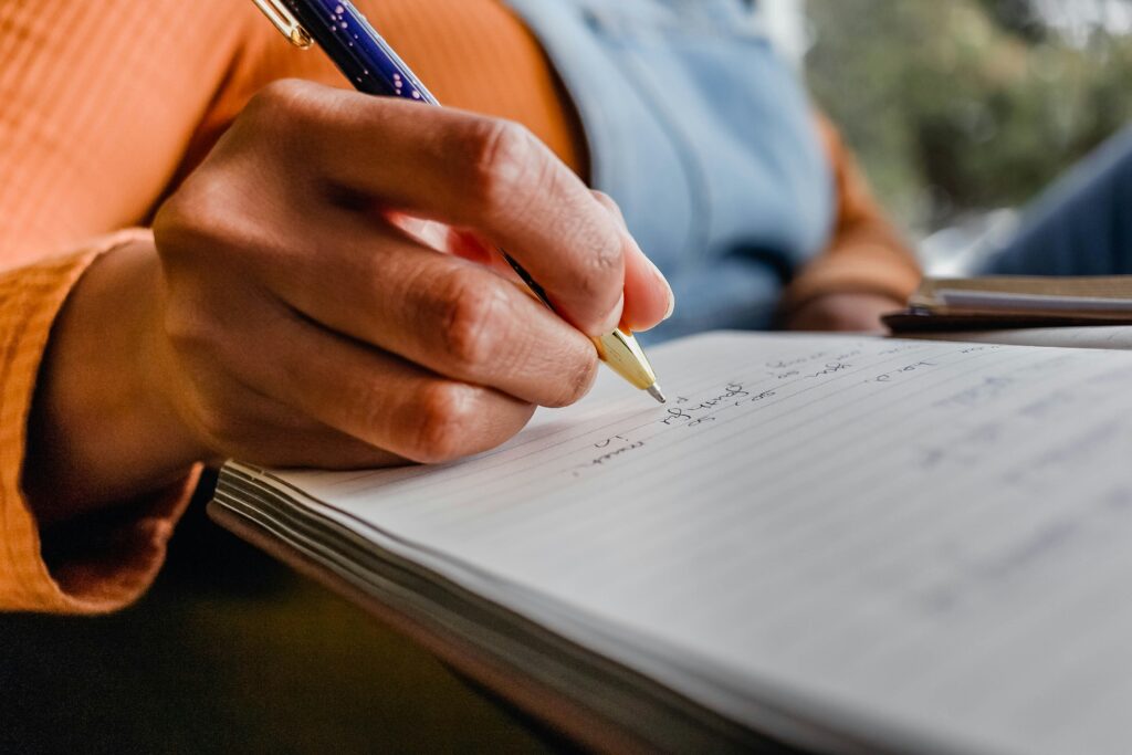 Woman writing on a diary